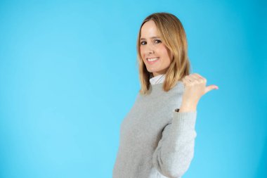 Yan profil fotoğrafını kapat güzel bayan kol parmağı parmağı boş uzay giysisi münferit mavi arka plan