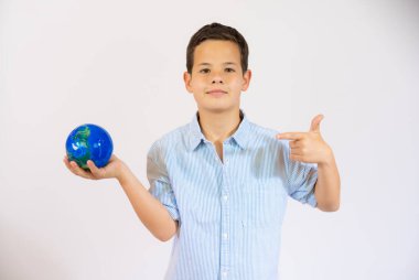 School boy showing a world globe isolated over white background