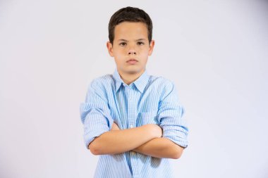 Little boy with arms folded isolated over white background