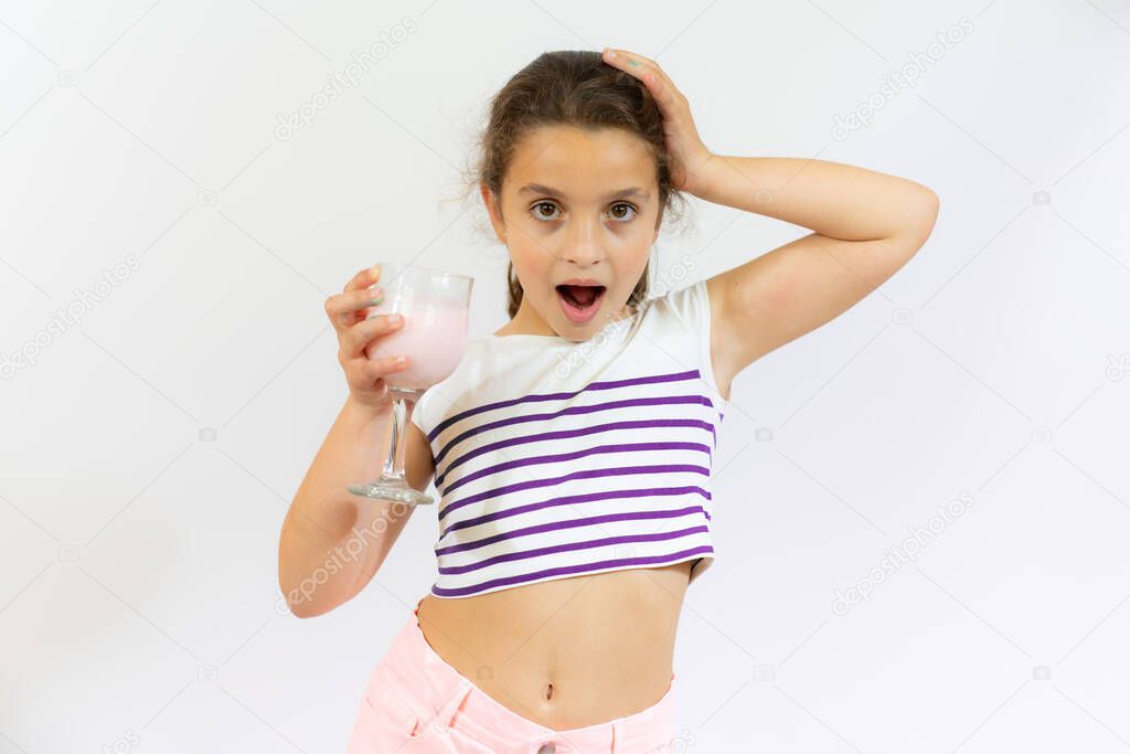 Smiling little kid hold smoothie bottle isolated over white background. Healthy concept.