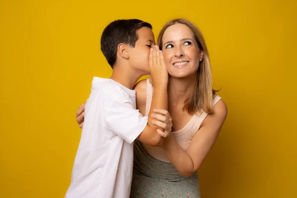 Boy Telling His Mother Family Secret Isolated Yellow Background — Foto de Stock