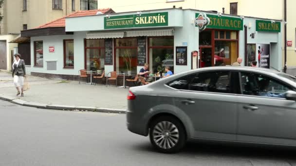 Restaurant(Pub) exteriör - två män sitter på stolar - urban street: förbipasserande bilar — Stockvideo