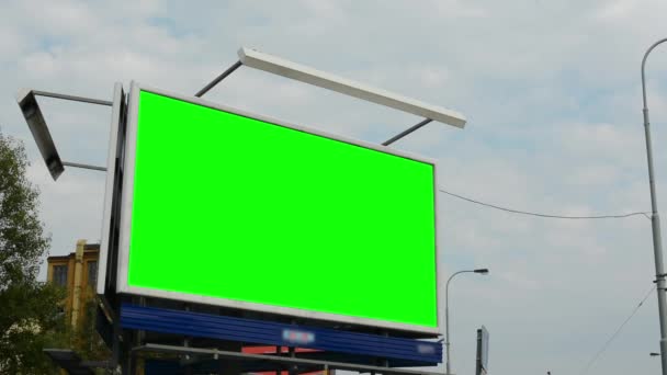 Billboard in the city near road - green screen - buildings in background — Stock Video