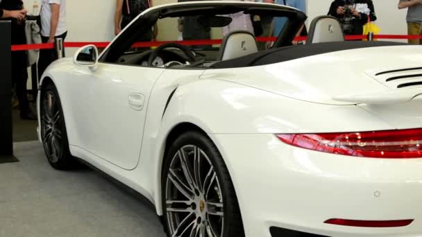 Porsche 911 turbo cabrio car (exterior) - side - people on exhibition — Stock Video