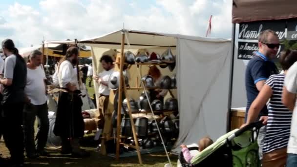 People walk on the exhibition - stalls with ancient goods and food - ground — Stock Video