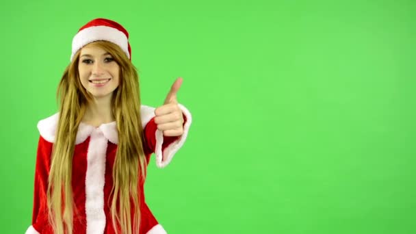 Christmas - Holidays - young attractive woman - green screen - woman agrees (showing thumb on agreement) — Wideo stockowe