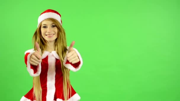 Різдво - свята - молода приваблива жінка - зелений екран - жінка погоджується (показати великі пальці за погодженням ) — стокове відео