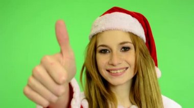 Christmas - Holidays - young attractive woman - green screen - woman agrees (showing thumbs on agreement)