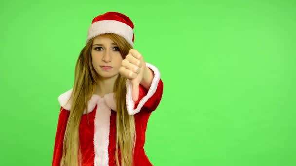 クリスマス - 休日 - 若い魅力的な女性 - グリーン スクリーン - 女性反対 (意見の相違に親指を表示) — ストック動画