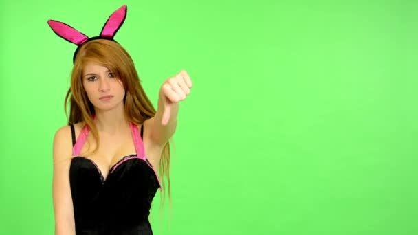 Young erotic woman - green screen - portrait - sexy flirting model - studio - woman disagrees (showing thumbs on disagreement) — Stock Video