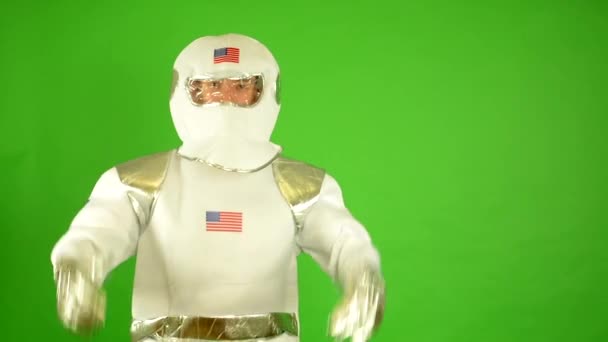 Astronaut setzt Helm auf und blickt in Kamera - grüner Bildschirm — Stockvideo