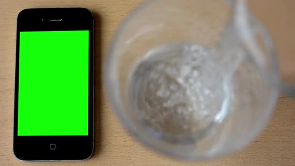 Smartphone - green screen - glass - pouring water — Stock Video