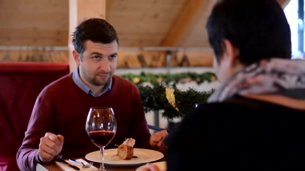 Casal feliz no restaurante - o homem come a comida — Vídeo de Stock