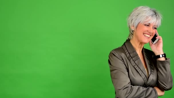 Business middle aged woman phone and smiles - green screen - studio — Stock Video