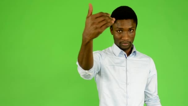 Young handsome black man invites - green screen - studio — Stock Video