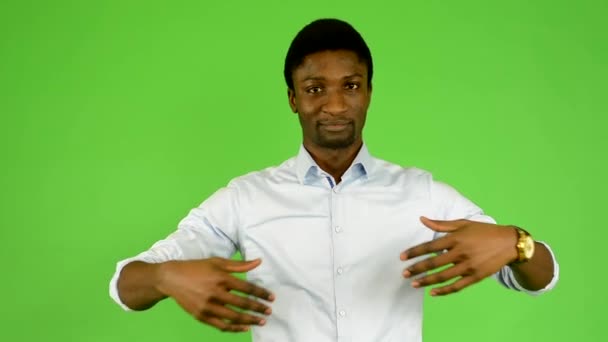 Young handsome black man welcome - green screen - studio — Stock Video