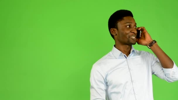 Young handsome black man phone - green screen - studio — Stock Video