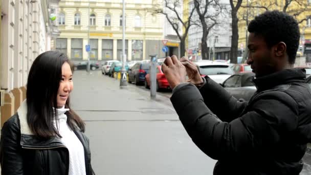 Happy couple take photo - black man and asian woman - urban street - city — Stock Video