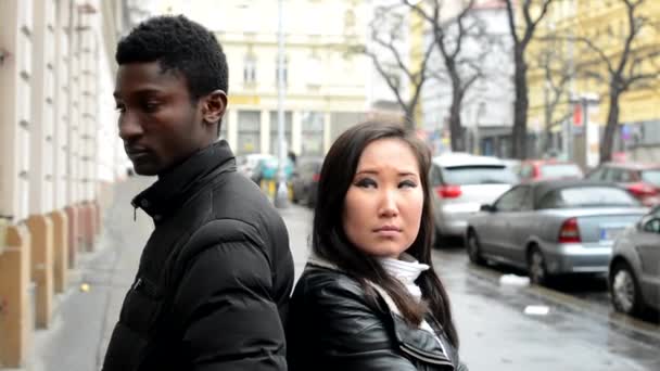 Unhappy couple are offended - black man and asian woman - urban street with cars - city — Stock Video