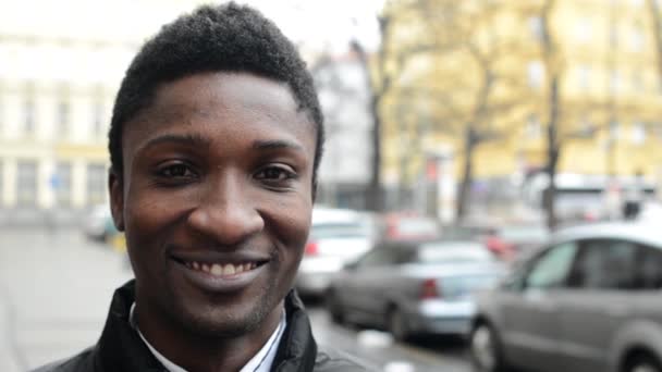 Young handsome black man smiles - urban street with cars - city - closeup — Stock Video