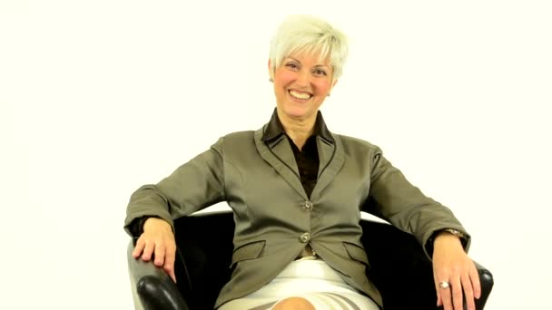 Business middle aged woman smiles to camera - white background - studio — Stock Video