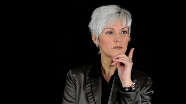 Business middle aged woman thinking - black background - studio — Stock Video