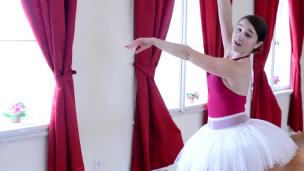 Young attractive ballerina doing funny grimaces and dance - interior - red curtain — Stock Video