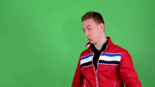 Young handsome man is crazy: swing with messenger bag  - green screen - studio — Stock Video