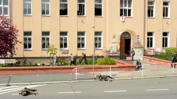 Prag, Tschechische Republik - 2. Mai 2015: Nachstellung der Schlacht des Zweiten Weltkriegs auf der Straße - Soldaten schießen aufeinander und Sanitäter tragen einen toten Unschuldigen fort — Stockvideo