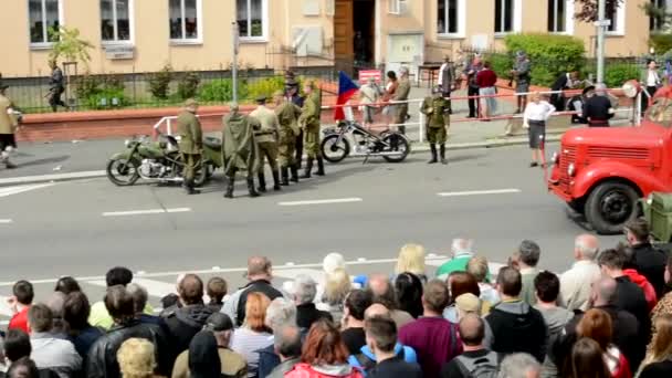 PRAGUE, CZECH REPUBLIC - MAY 2, 2015: reenactment performance battle of World War II on the street - soldiers and audience (viewer) - end of performance - vintage ambulance — Stock Video