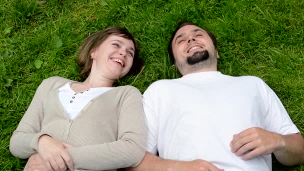 Middle aged couple in love lying in grass and talk — Stock Video