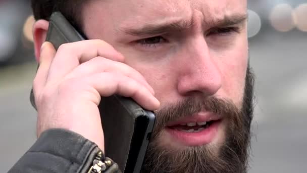 Young handsome hipster man phone with smartphone - city - urban street - closeup face — Stock Video