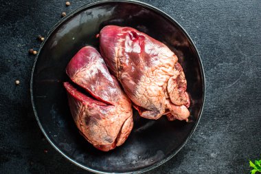 Çiğ domuz ya da sığır kalbi eti ikinci tabak aperatif masada yemeye hazır sağlıklı yemek malzemeleri üst görünüm fotokopi alanı metin gıdası arka plan kırsal keto ya da paleo diyeti için