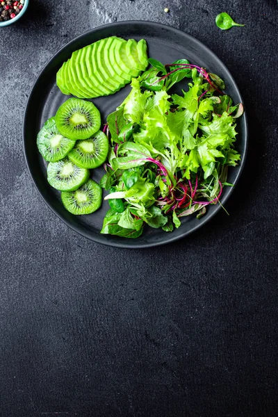 kiwi salad avocado lettuce mix leaves ready to cook and eat on the table for healthy meal snack outdoor top view copy space for text food background rustic image keto or paleo diet