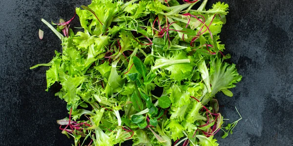 Healthy salad, leaves mix salad mix micro greens, juicy snack ready to cook and eat on the table for healthy meal snack outdoor top view copy space for text food background rustic image keto or paleo