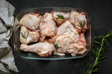 Siyah arka planda baharatlı ve otlu çiğ tavuk. yakın çekim görünümü.