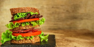 sandwich with dried meat slices and vegetables