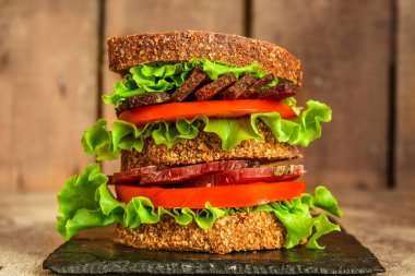 sandwich with dried meat slices and vegetables