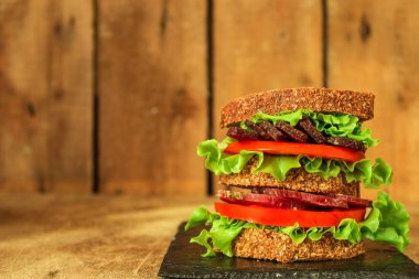 sandwich with dried meat slices and vegetables