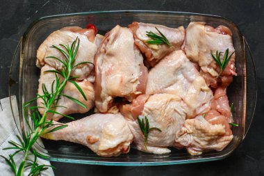 Siyah arka planda baharatlı ve otlu çiğ tavuk. yakın çekim görünümü.