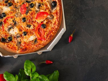 Siyah arka planda pepperonili pizza, domates, peynir, mantar ve zeytin. en üstteki görünüm.
