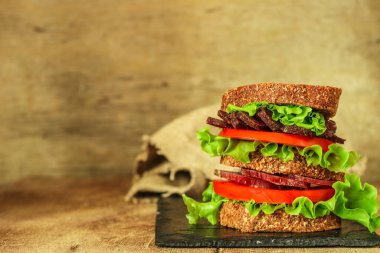 sandwich with dried meat slices and vegetables