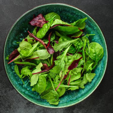 Salata yaprakları karışır, sulu atıştırmalıklar masanın üstünde yemeye hazırdır.