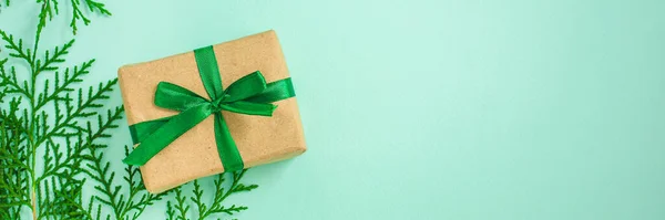 Вид Зверху Подарункової Коробки Стрічкою Зеленими Гілочками Яскравому Фоні — стокове фото