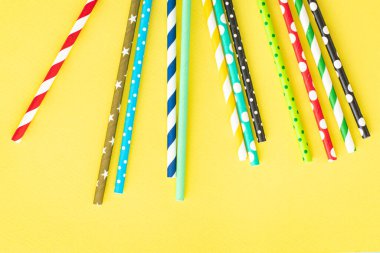 paper straws multicolored striped dotted straws scattered Flat lay useful ecology cocktail or juice, lemonade to usebiodegradable on the table concept party healthy meal copy space food background