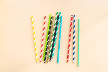 paper straws multicolored striped dotted straws scattered Flat lay useful ecology cocktail or juice, lemonade to usebiodegradable on the table concept party healthy meal copy space food background