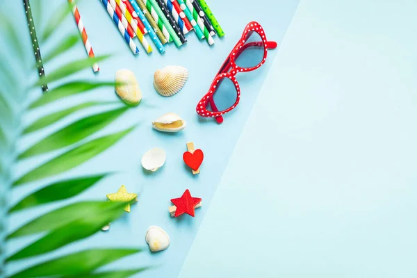 summer mood background, tropical leaf, sunglasses, seashells, multicolored cocktail tubes accessories, travel vacation, ocean, sea, summer relax mood top view