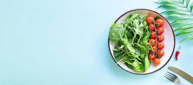 tomato cherry salad green leaves fresh mix greens spinach, arugula, lettuce healthy food meal copy space food background keto or paleo diet vegan or vegetarian food 