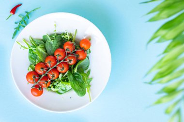 tomato cherry salad green leaves fresh mix greens spinach, arugula, lettuce healthy food meal copy space food background keto or paleo diet vegan or vegetarian food 