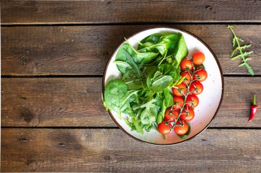 tomato cherry salad green leaves fresh mix greens spinach, arugula, lettuce healthy food meal copy space food background keto or paleo diet vegan or vegetarian food 